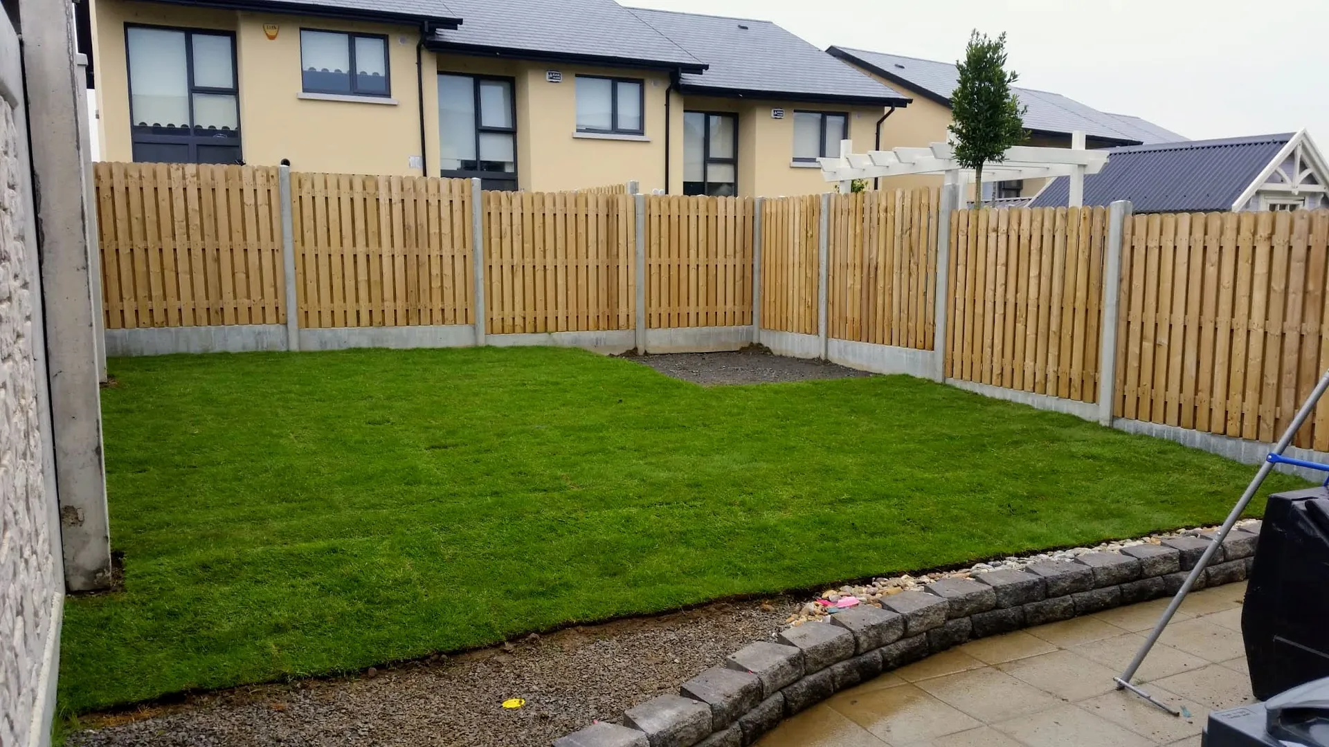 Freshly laid turf lawn with timber fencing in a back garden, North Dublin